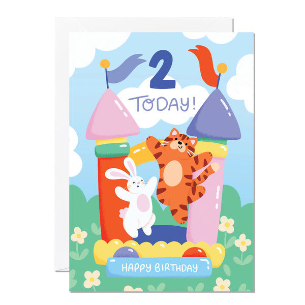 A colourful 2nd birthday card with a tiger and a rabbit on a bouncy castle.