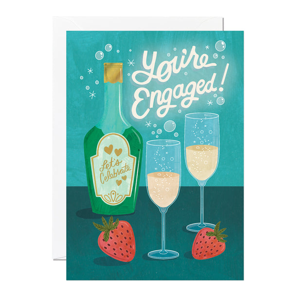 A greeting card with an illustration of a green bottle labelled 'let's celebrate!' and two glasses of champagne, surrounded by bubbles and a strawberry on a blue background.