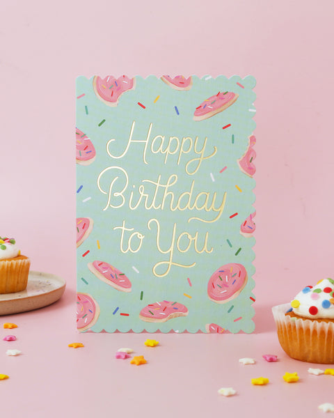 Birthday card with sugar cookie design and 'Happy Birthday to You' text on a teal background