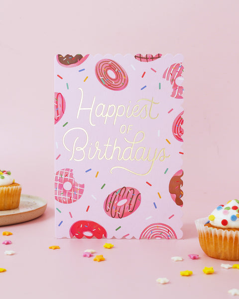Birthday card with donut and sprinkles design on a pink background