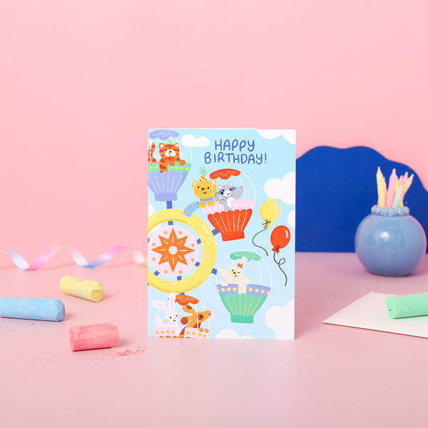 A children's birthday card with animals on the ferris wheel.
