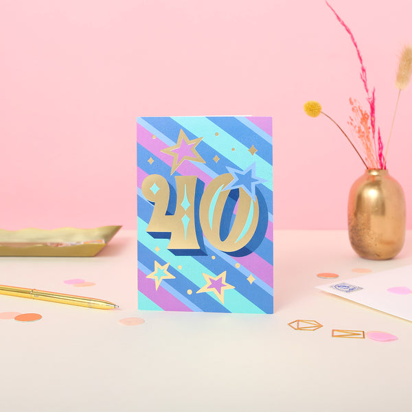A 40th birthday card with a colourful striped background and gold foil number 40 text.