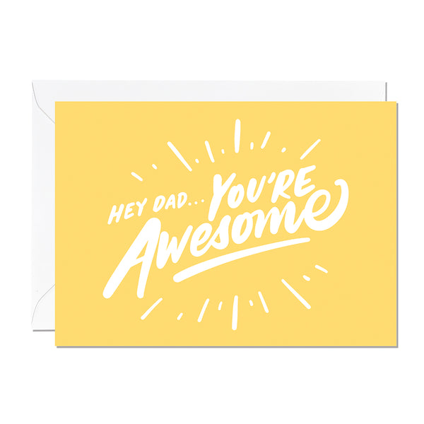 A father's day card that features a hand lettered greeting that reads 'Hey Dad, You're Awesome' printed on a yellow background