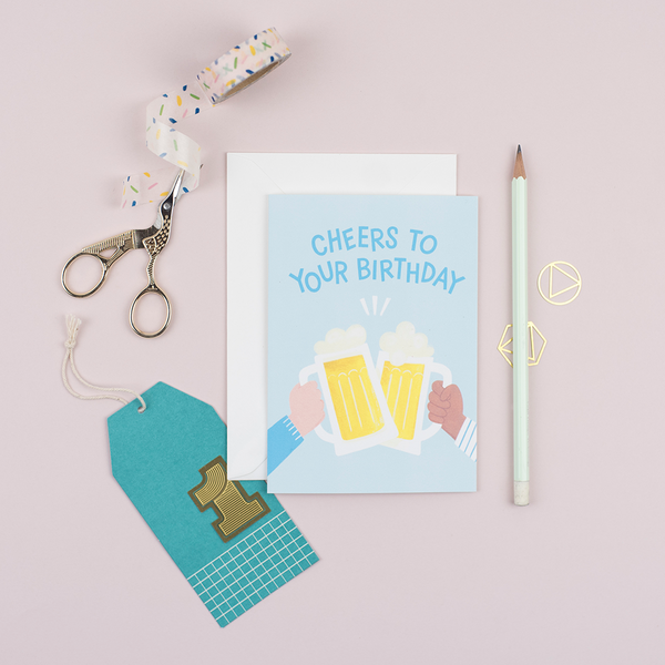 A male birthday card that has been hand-painted with two clinking beers and a greeting that says 'cheers to your birthday'
