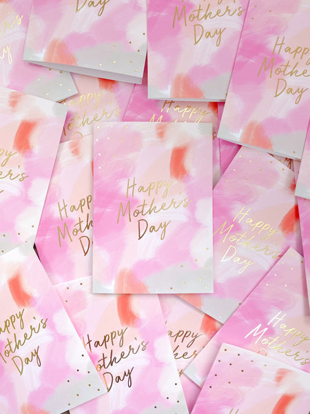 A mother's day card featuring a hand-painted canvas background and gold foil lettering that says 'happy mother's day'