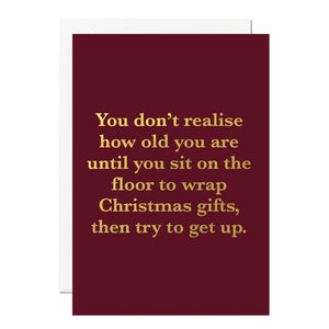 Funny Maroon Christmas card with gold text on a white background