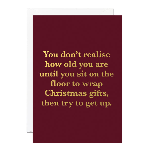 Funny Maroon Christmas card with gold text on a white background