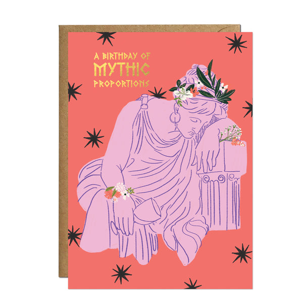 An artistic pink and coral birthday card featuring a draped Greek figure wearing a flower crown and leaning elegantly against a classical marble column.