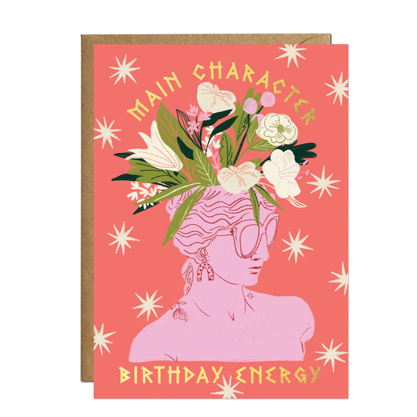 A maximalist coral birthday card illustrating a pink marble silhouette with drop earrings, sunglasses, and a spectacular crown of blooming lilies and wildflowers.