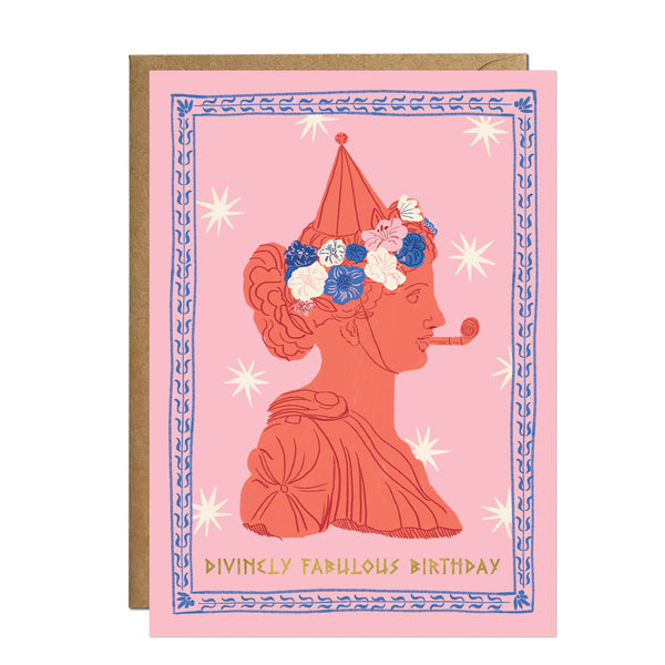 A playful terracotta-toned greeting card showcasing a Greek figure wearing a floral wreath and a striped party hat while blowing a celebratory party horn.