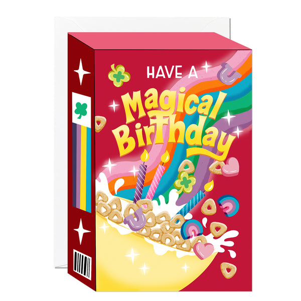 A die-cut birthday card depicting a whimsical marshmallow cereal box with a vibrant rainbow, magical charms, and colourful birthday candles.