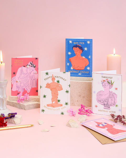 Collection of birthday cards with artistic designs on a pink background