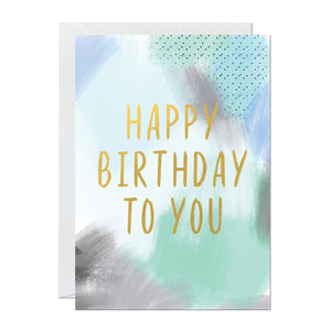 A birthday card perfect for men with a green and blue painted canvas background and a gold foil greeting reading 'happy birthday to you'