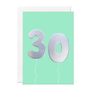 A 30th birthday card with birthday balloons that have been printed with an embossed silver foil on a mint greeting card