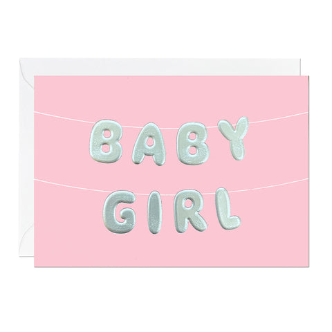A pink baby girl greeting card featuring letter bunting printed with an embossed foil