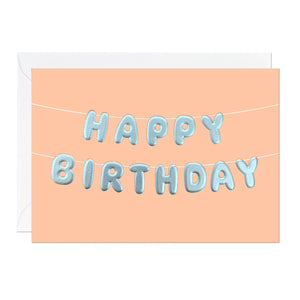 An orange birthday card with birthday bunting that reads 'happy birthday' printed with an embossed silver foil