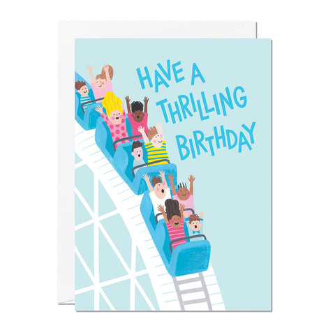 A kid's birthday card featuring an illustration of a rollercoaster with children having lots of fun and a caption that reads 'have a thrilling birthday'