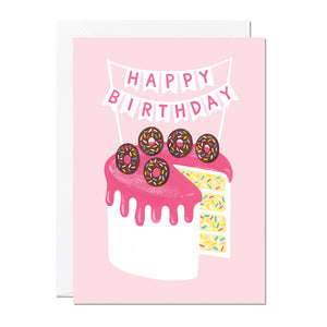 A birthday card featuring a hand-painted birthday cake with doughnuts and confetti sponge