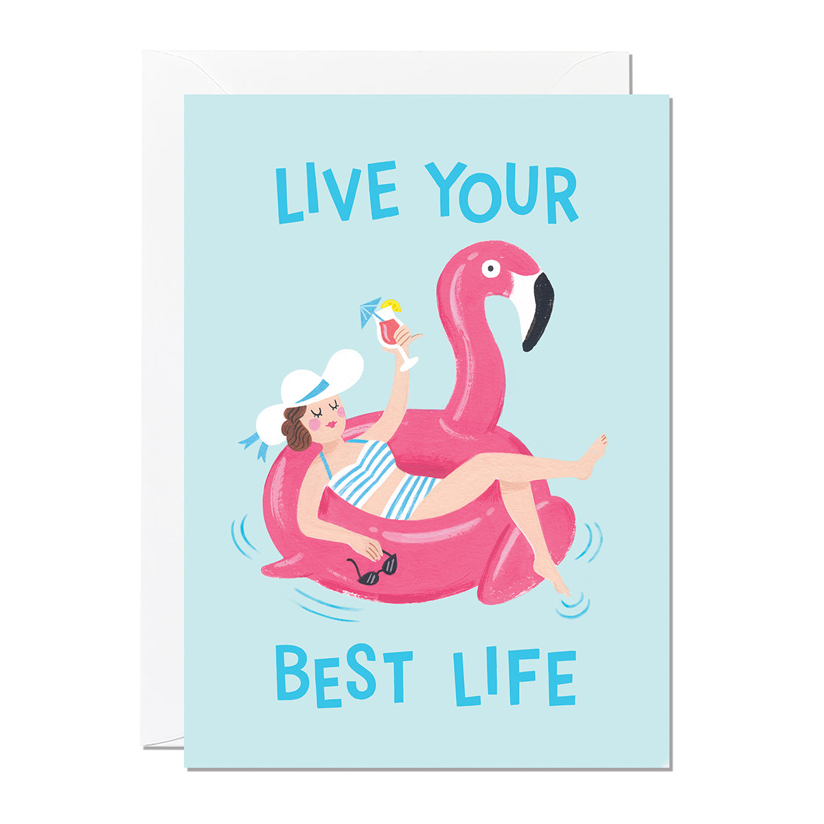 A birthday card that features an illustration of a woman holding a cocktail lounging on a flamingo pool float with a greeting that reads 'Live Your Best Life'