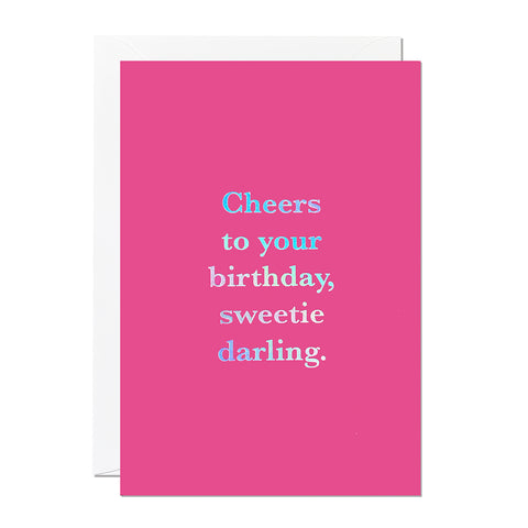 This birthday card takes inspiration from the TV show Absolutely Fabulous and has the greeting 'Cheers to your birthday sweetie darling' printed on a hot pink background with an iridescent foil finish.