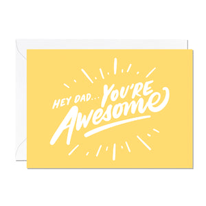A father's day card that features a hand lettered greeting that reads 'Hey Dad, You're Awesome' printed on a yellow background