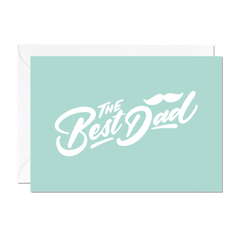 A father's day card that features a hand lettered greeting that reads 'the best dad' printed on a mint green background