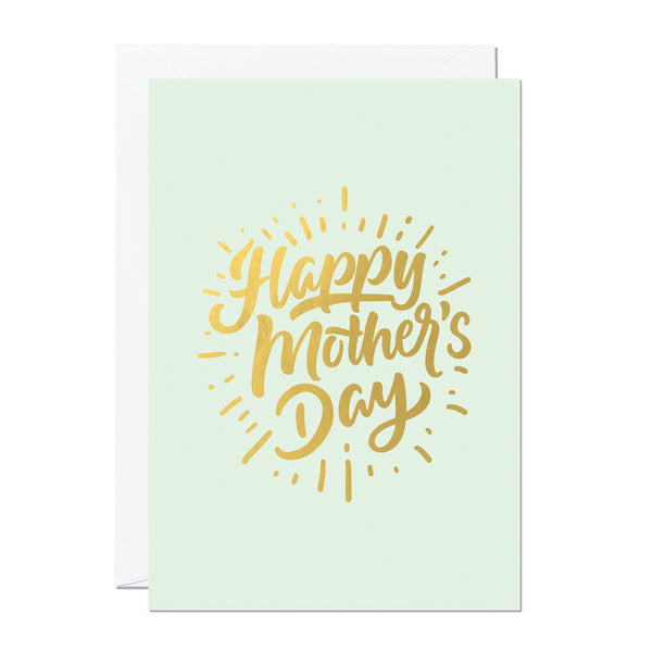 This is a Mother's Day card that says 'Happy Mother's Day'. It's printed with a light green background and features hand lettering printed with a luxury gold foil