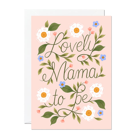 A baby shower greeting card that says 'lovely mama to be' with hand lettering and hand drawn flowers.