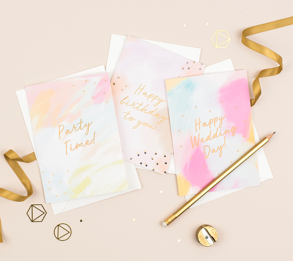 A birthday card featuring a hand-painted background and a gold foil greeting that reads 'birthday wishes'