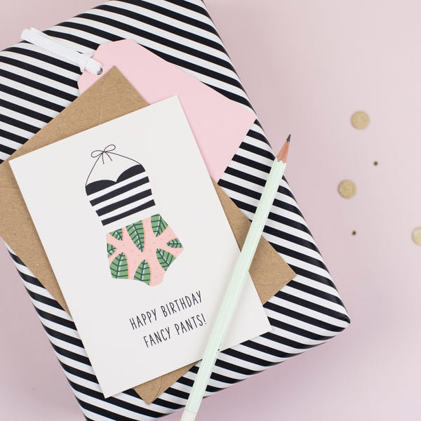 A birthday card featuring an illustration of a women's swimsuit and a greeting that reads 'happy birthday fancy pants'