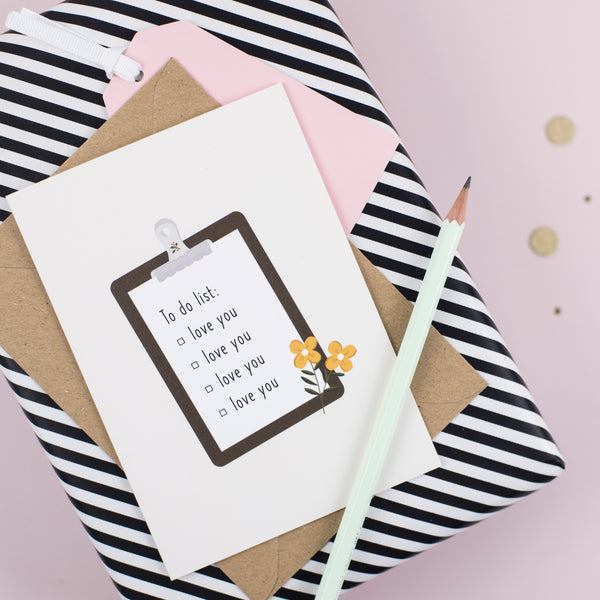 A greeting card with an illustration of a list pad which has a list of to-dos saying 'love you' repeatedly