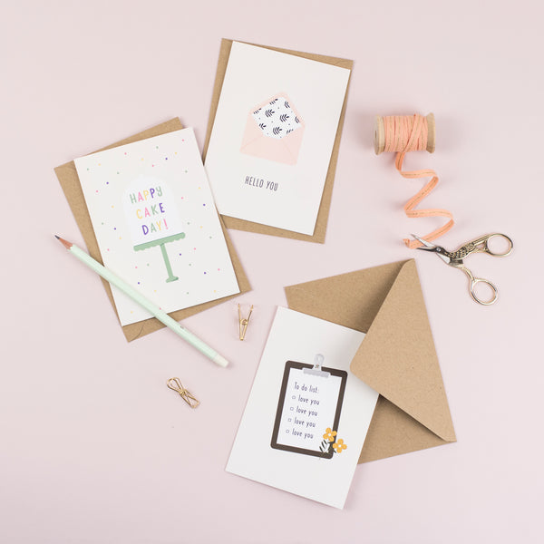 A birthday card featuring an illustration of an ice cream with a greeting that reads 'birthday treats' paired with a kraft brown envelope